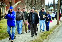 Tom Fink takes his turn carrying the cross on Good Friday morning.