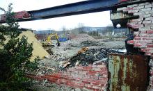 What's left of an old Bloomsburg Mills building sits sorted into piles of bricks, steel and other debris as demolition on the site continues.