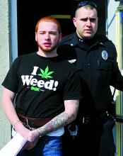 Trevor Christman, 18, Coaldale, is led out of District Judge Marvin Shrawder's court by Bloomsburg University police officer Dan Erdman after being arraigned Sunday on charges he struck a BU student and robbed him of his cell phone.