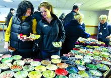 Donna Murphy, left and daughter Ali-Marie Murphy select their hand-painted bowls at Kehr Union ballroom at the annual Empty Bowls banquet Sunday at Bloomsburg University.