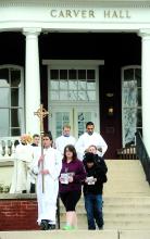 Lucas Liberacki, carries the cross as he leads the members of the Catholic Campos Ministry on their Maundy Thursday procession.