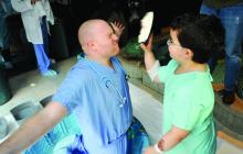 Eight-year-old Alan Lyter, Pleasant Gap, prepares to push a cream pie into the face of Dr. Scott Vascik at the Janet Weis Children's Hospital at Geisinger Friday afternoon.