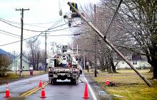 A PPL crew removes a street light from a broken Verizon utility pole along Old Berwick Road in South Centre Township on Tuesday morning.