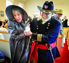 Bloomsburg Theatre Ensemble member Elizabeth Dowd, portraying a distressed Mrs. Burnside, is helped out of the courtroom by Montour County Commissioner Jerry Ward, a Danvillian upstart, during the re-enactment to start the Columbia County Bicentennial at the Columbia County Courthouse on Friday.