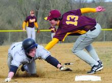 Southern Columbia's Garrett Sosnoski, left, is tagged out while diving into third base by Saint John Neumann's Nick Grieco on a double by Mason Peters in the second inning of Wednesday afternoon's game at Southern. 