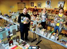 Volunteers, from left, CJ Moholland, Robert Dunkelberger, Midison Fox and Christian Tloczynski display some of the books they are arranging for the 14th annual Friends of the Bloomsburg University Library Association book sale in the Andruss Library on campus this weekend. Sale hours are Saturday, 1-4 p.m.; Sunday, 1-3 and 6-9 p.m.; and Monday, 10 a.m. to 4 p.m. Proceeds benefit FOBULA student scholarships. Parking is free on campus on the weekend.