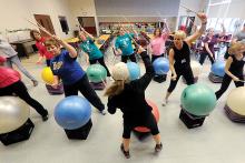 Certified trainer Cindy Wasilewski, center foreground, leads a class of 12 students at the Bloomsburg Middle School cafeteria in an eight-hour class for the Drums Alive program Sunday afternoon. Students in the class included from teachers and para-educators to members of the community. 