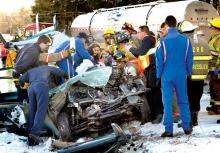 Rescue workers move Kyle Halat, 26, Jonestown, out of his 2002 Geo Tracker after his subcompact SUV skidded on an icy stretch of Route 487 into an oncoming milk tanker truck on Monday morning.