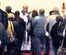 The Rev. Francis Tamburro places ashes on the foreheads of the faithful during an Ash Wednesday service at noon at St. Mary’s Church in Berwick.
