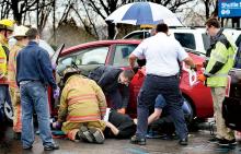Rescue workers tend to a woman who was caught under her Toyota Prius in the parking lot at Geisinger Medical Center in Danville on Wednesday. 