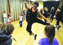 Central Columbia High School dance team member Sabriba Sepulveda, center, leads a group of elementary students in a dance class during the Central Columbia Elementary's annual Super Saturday evening, held at the school. 