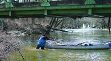 Eric Grace from Creek Cleanup Project walks down Fishing Creek in Fernville cleaning up debris along the bank loading whatever he finds into his canoe Sunday afternoon.