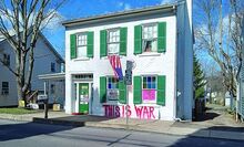 Ramona Schaffer has covered her home on Main Street in Orangeville with anti-President Trump views. (Press Enterprise/Leon Bogdan)