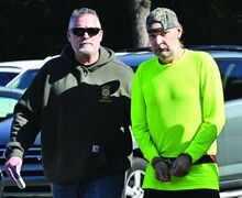 Berwick Police Sgt. Greg Martin escorts Todd Michael Ipher into District Judge Russell Lawton’s court Tuesday morning. Officers say he fired a gun three times through the wall of his apartment while at three other people were in the building. Ipher said he was shooting at an intruder who was coming through the wall.