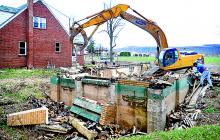 A crew demolishes the former home of Gregory Lindner at 940 West Main Street in Bloomsburg.