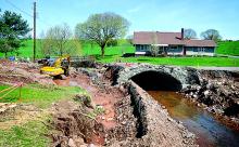 A PennDOT bridge crew begins the replacement of an aging stone-arch bridge on Bear Gap Road.