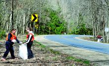 Southern Columbia High School juniors Teanna Shutt, left, and Racquel Kreischer pick up roadside litter along Route 42 in the Weiser State Forest.