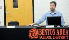 Benton School Board President Eric LeFevre makes a statement about the empty seat next to him where Superintendent Penny Lenig-Zerby usually sits after the board reconvened following an executive session to discuss personal during Monday night's meeting.