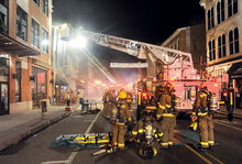 Members of Catawissa Fire Company’s RIT team stand in the foreground on Mill Street in Danville as crews set up fans in the doorway to ventilate BJ’s Steak and Rib House while fighting Sunday night’s fire at the popular restaurant. For more, see our story on Page 1. 