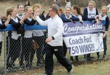 Central Columbia's head coach Duane Ford walks down a line of his players getting congratulated after they presented him with a banner for his 750th career win follow the team beating Loyalsock 10-5 Thursday afternoon at Central.