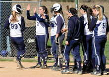 Central Columbia’s Allison McCracken, left, steps on home plate as she is met by her teammates after a three run homer in the first inning of Thursday afternoon’s game against Warrior Run at Central.