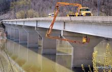 A PennDOT bridge inspection crew uses a crane to get a look under the East Bloomsburg bridge over the Susquehanna River on Monday morning. 