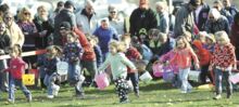 Children race from the starting line to find their Easter eggs at the Espy Fire Company’s annual Egg hunt Saturday morning in Scott Township.