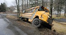 A Northwest Area school bus leans over the embankment after going through an utility pole and hitting a tree along Apache Drive near Shickshinny Lake Friday afternoon. The driver was taken to the hospital, but no kids were on board.