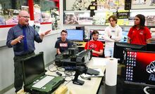 Bloomsburg robotics teacher, Kirk Marshall, left, talks about the robot that the class fixed for the Bloomsburg Police on Thursday at the Bloomsburg High School. 