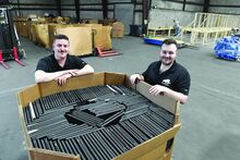 Mamoth’s Cody Meredick, vice president of sales, left, and Anthony Boberick, CEO, stand next to a box containing 500 Chromebooks Tuesday in their new facility at the BIDA complex in Berwick. Their new building is 16 times larger of their currently in Union Township outside of Shickshinny. 