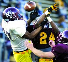 Bloomsburg receiver Devante Johnson, left, has a pass broken up by Maroon defender Travon Pugh Friday at BU's Maroon and Gold game.