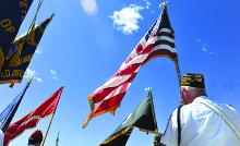 Kurtis Raber, right, of the Berwick VFW, holds the American flag during the Berwick-Nescopeck Memorial Day parade Sunday.
