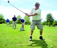 Tracy Walker, Berwick, takes a swing on the driving range at Mill Race Golf Course during First Swing, a golfing event held for handicapped or disabled people Friday afternoon in Benton.