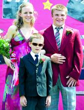 Crown bearer Emmitt Yost, center, a first-grade student, poses with the queen and king of Benton's 72nd May Day celebration, Jessica Metcalf, 18, daughter of Brad and Susan Metcalf, Benton and Colt Cotten, 18, son of Fawn Cotten, Benton, after the two were crowned Wednesday.