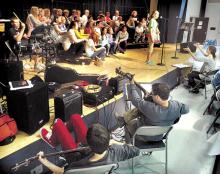 Jess Thatcher sings a solo as teacher Erin Lehman directs the rehearsal of the American Music Documentary in the Central Columbia Middle School on Wednesday afternoon.