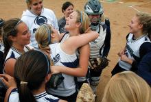 Central Columbia’s Marissa Shelhamer, center left, hugs pitcher Paige Siegrist while standing among teammates as they celebrate winning the district title game against Towanda on the field Thursday afternoon at Elm Park in Williamsport.