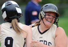 Southern Columbia’s Taylor Hoffman, right, is met after crossing home plate by teammate Jadyn Dunkelberger following Hoffman’s two-run homer in the fifth inning of Friday afternoon’s game against Muncy at Muncy.