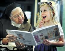 St. Cyril Academy kindergarten student Hadley Starankovic, 5, of Danville, reads from the ABC book that she made to Sister Anne Mika on Thursday. Students in teachers Sally Meginley’s and Betsy Finn’s classes each made an ABC book and read from their books to the sisters living at Maria Hall.