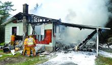 Firefighters work to douse hot spots after a home in the 300 block of the Old Tioga Turnpike in Fishing Creek Township burned Friday afternoon.