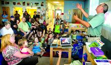 Rand Whipple, at right, of Box of Light works with Head Start children at the Town Park Village Center in Bloomsburg during a program where parents got the chance to see what their children have been doing with cameras and iPads in the classroom. 