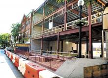 The enclosed temporary sidewalk in front of the Bloomsburg University Foundation’s Greenly Center construction site at 50 East Main Street in Bloomsburg has been disassembled and closed while workers connect underground water lines. Pedestrians are being directed to use the crosswalks to the north side of Main Street to get around the closed sidewalk, seen here on Monday morning. The closure is expected to last less than one week.