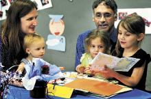 St. Columba School kindergarten student Maryellen Faus, right, reads from the story she wrote during a kindergarten celebration in the Bloomsburg parochial school on Wednesday morning. Listening are members of her family, from left, mom Martha, sisters Annabelle and Gwendolyn and dad Jim Faus, of Orangeville. St. Columba’s kindergarten teacher is Jennifer Mertz.