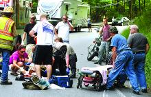 Rescuers tend to one of two riders of a Harley-Davidson motorcycle after a crash along Route 487 just south of Catawissa Borough Sunday afternoon.