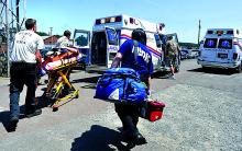 Emergency workers walk Krista Gearhart of Orangeville to an ambulance after an accidental shooting at the Eagle Arms Gun Show Saturday afternoon at the Bloomsburg Fairgrounds.