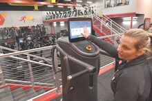 Amber Keishner, Berwick YMCA Wellness & Member Engagement Director, sits at one of the new EGYM pieces of strength equipment while talking about setting it up for each user Friday. The new area of the Y will open to the members on Monday. 