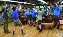 The members of Camp Lavigne staff sing a song after finishing lunch in the mess hall during staff week. The camp is celebrating its 100th anniversary this year.