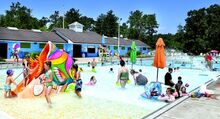 Children and adults escape the hot weather in the cooling waters of the Ber-Vaughn Pool on Monday afternoon. 