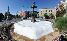 Water drains out of the middle level of the fountain in Bloomsburg after it was shut off Friday morning following someone putting something in the water to fill the fountain with bubbles. 