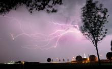 A cloud-to-cloud lightning bolt flashes through the western sky over Balanced Care at Bloomsburg, left, the Calvary Baptist Church and Bloomsburg Christian School along Ridge Road Wednesday night as a fast-moving line of storms crossed the area. 