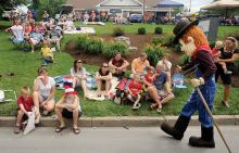 The Bloomsburg Fair's new mascot greets people along the parade route on South State Street Thursday morning at the annual Independence Day parade in Millville. 